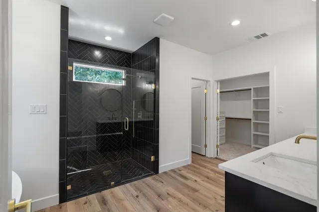 a bathroom with a shower and a sink
