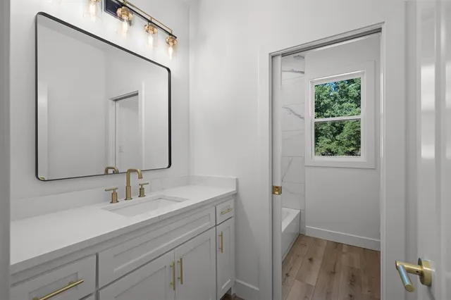 a bathroom with a sink a vanity and a mirror