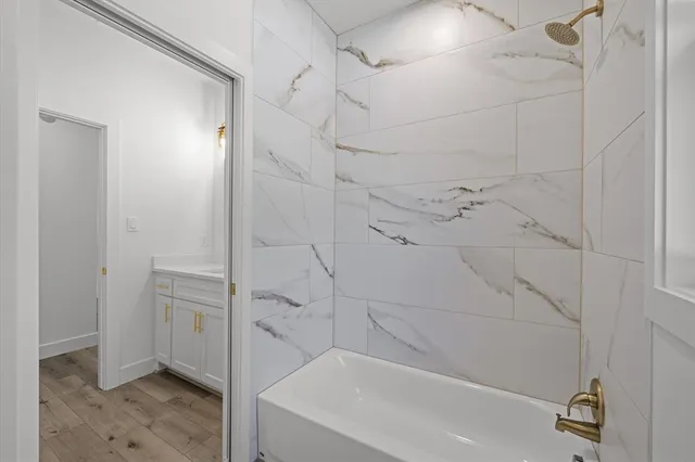 a bathroom with a bathtub and a shower