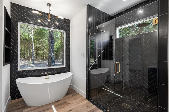 a bathroom with a bathtub and shower