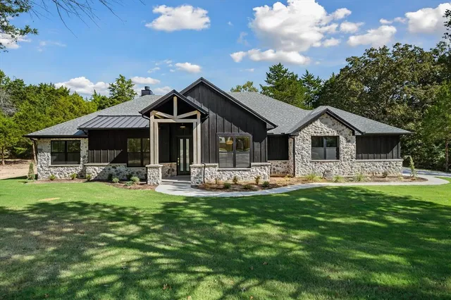 a front view of house with a garden and patio