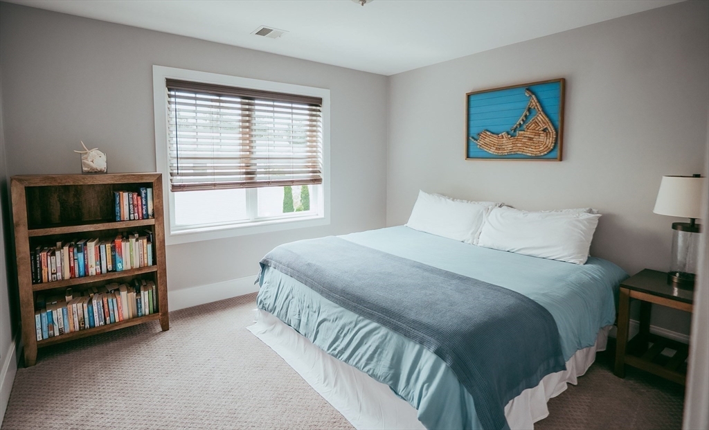 1 Proctor Street Natick, MA 01760 - Photo 16 of 23 a bedroom with a bed and a book shelf