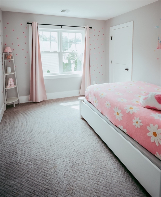 1 Proctor Street Natick, MA 01760 - Photo 18 of 23 a spacious bedroom with a bed and a window