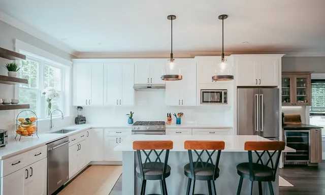 a kitchen with stainless steel appliances kitchen island granite countertop a sink and cabinets