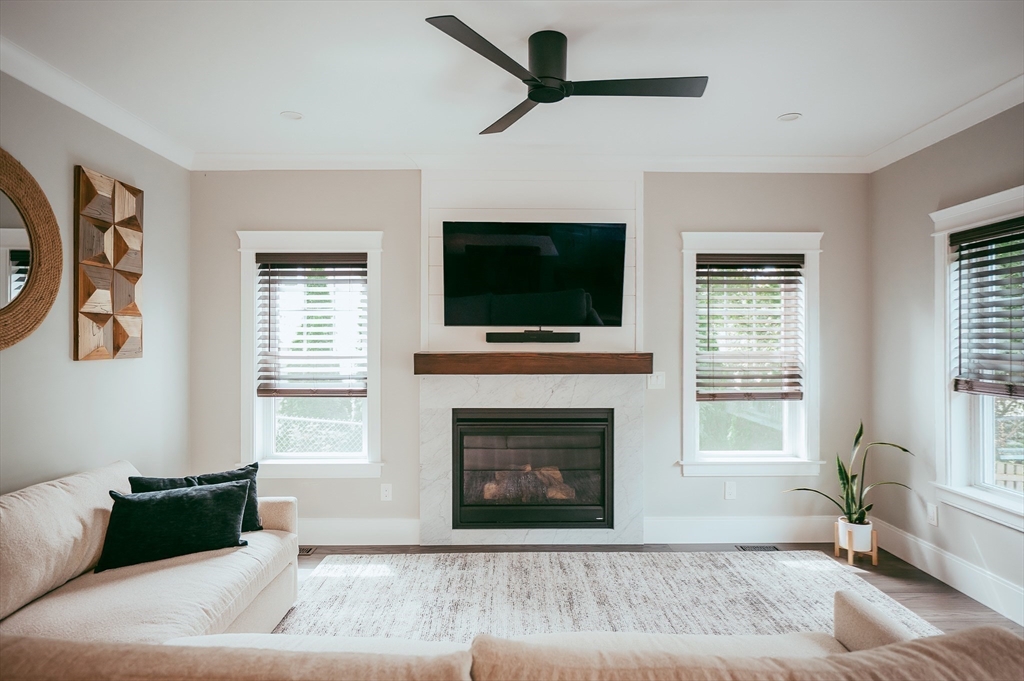 1 Proctor Street Natick, MA 01760 - Photo 10 of 23 a living room with furniture a flat screen tv and a fireplace