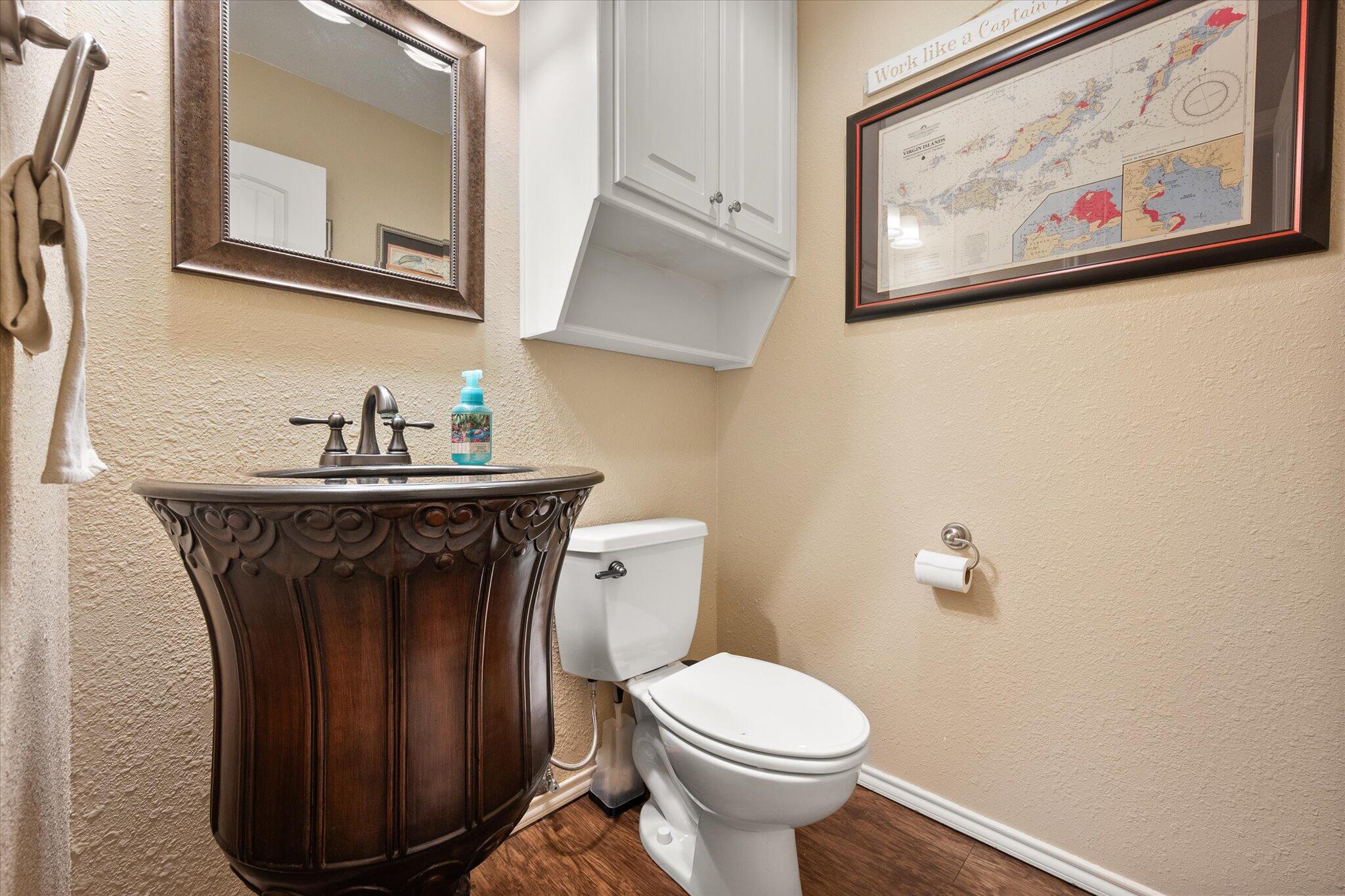 5908 110th Street Lubbock, TX 79424 - Photo 16 of 31 a bathroom with a toilet and a sink