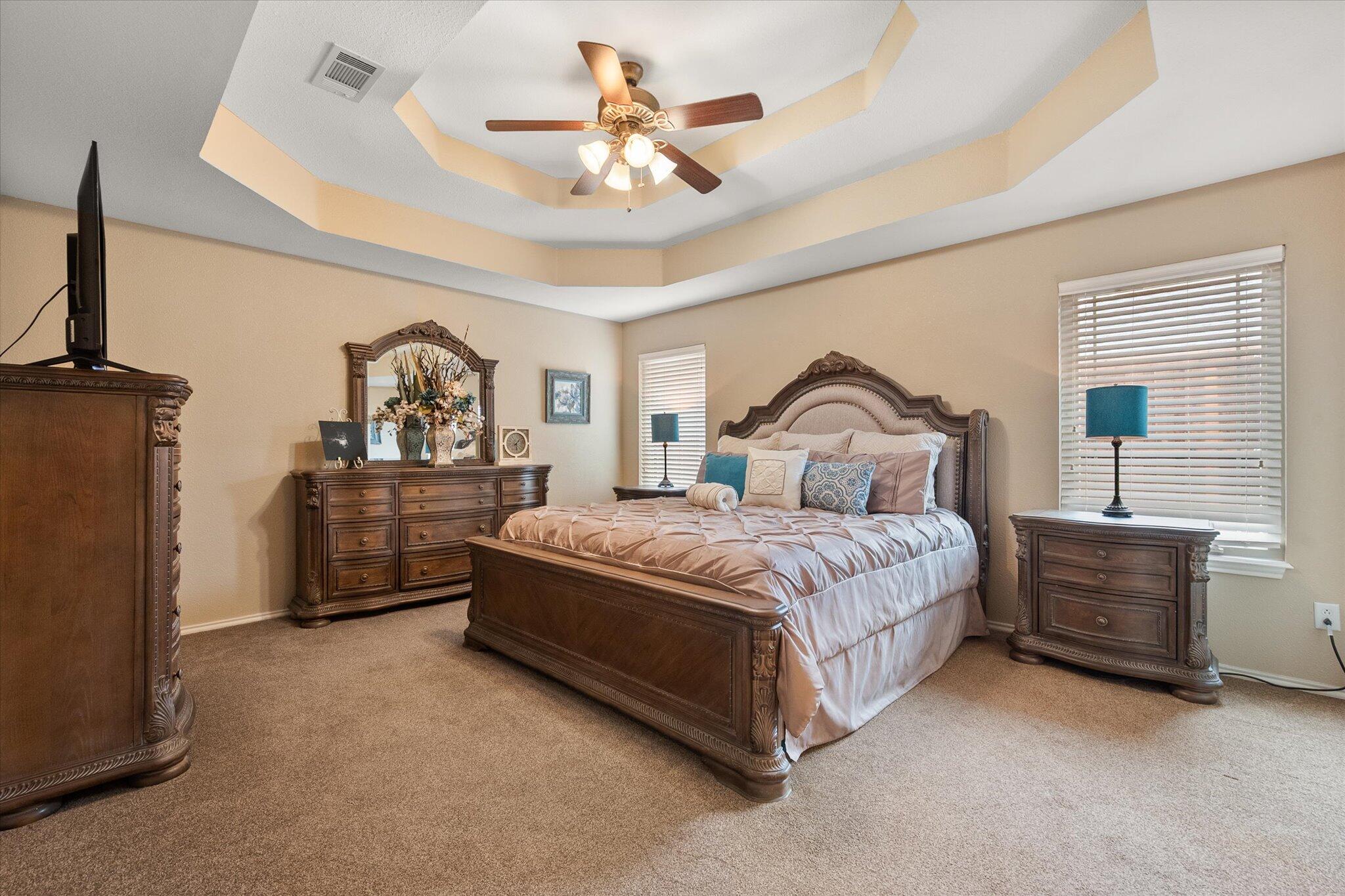 5908 110th Street Lubbock, TX 79424 - Photo 20 of 31 a bedroom with a bed dresser and a window