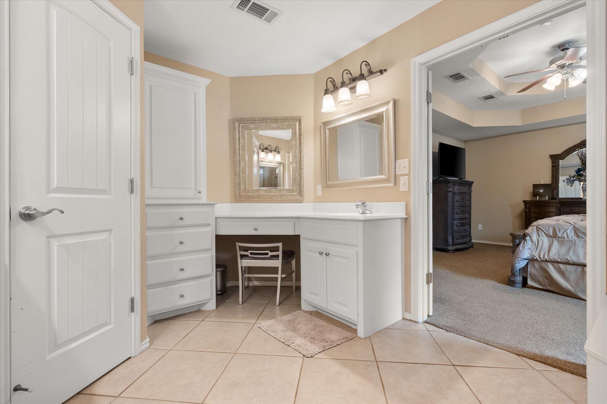 5908 110th Street Lubbock, TX 79424 - Photo 25 of 31 a bedroom with a bed and a cabinets