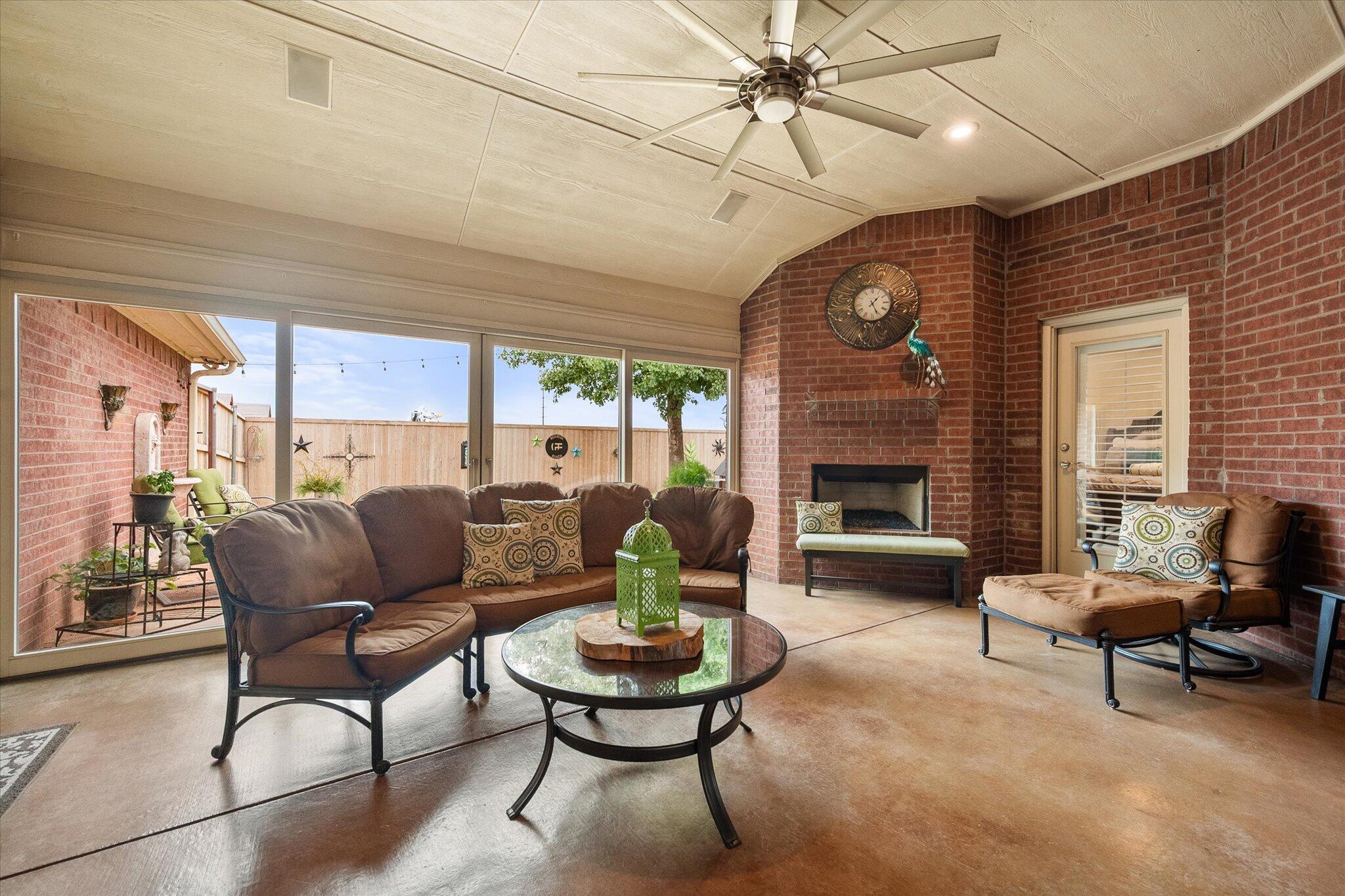 5908 110th Street Lubbock, TX 79424 - Photo 27 of 31 a living room with furniture and a fireplace