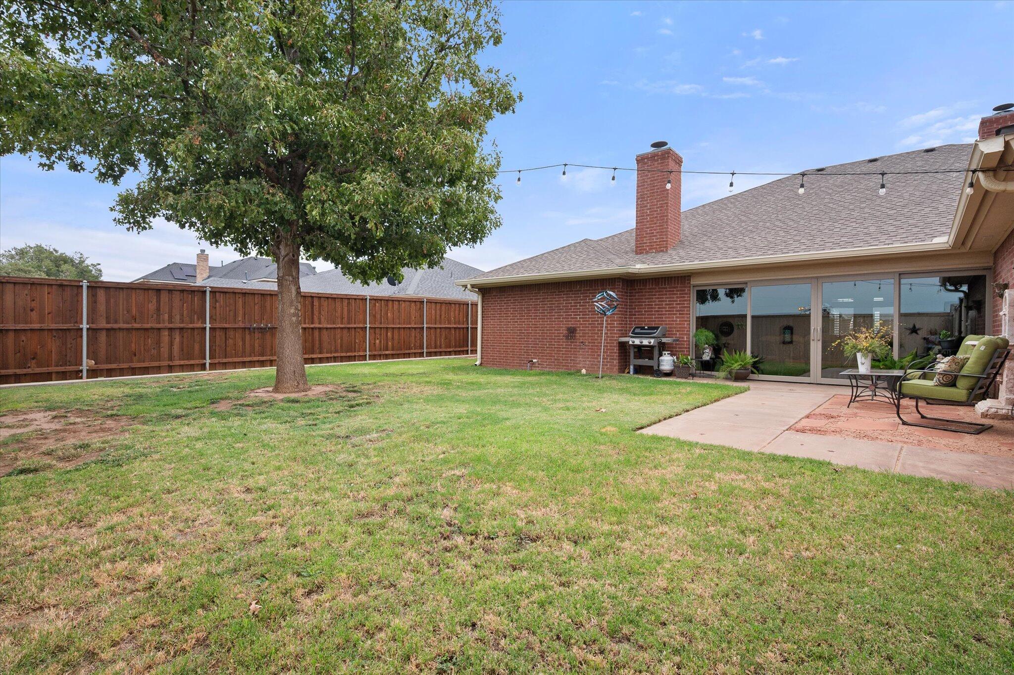 5908 110th Street Lubbock, TX 79424 - Photo 30 of 31 a view of a house with a yard and sitting area