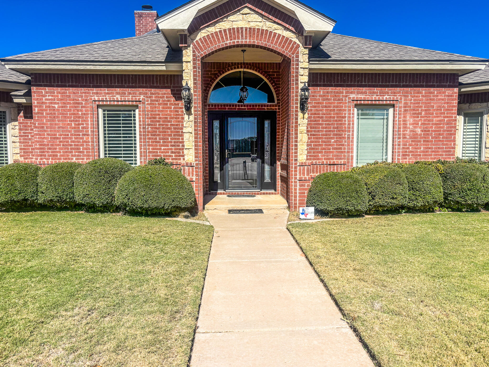 5908 110th Street Lubbock, TX 79424 - Photo 3 of 31 a front view of a building with garden