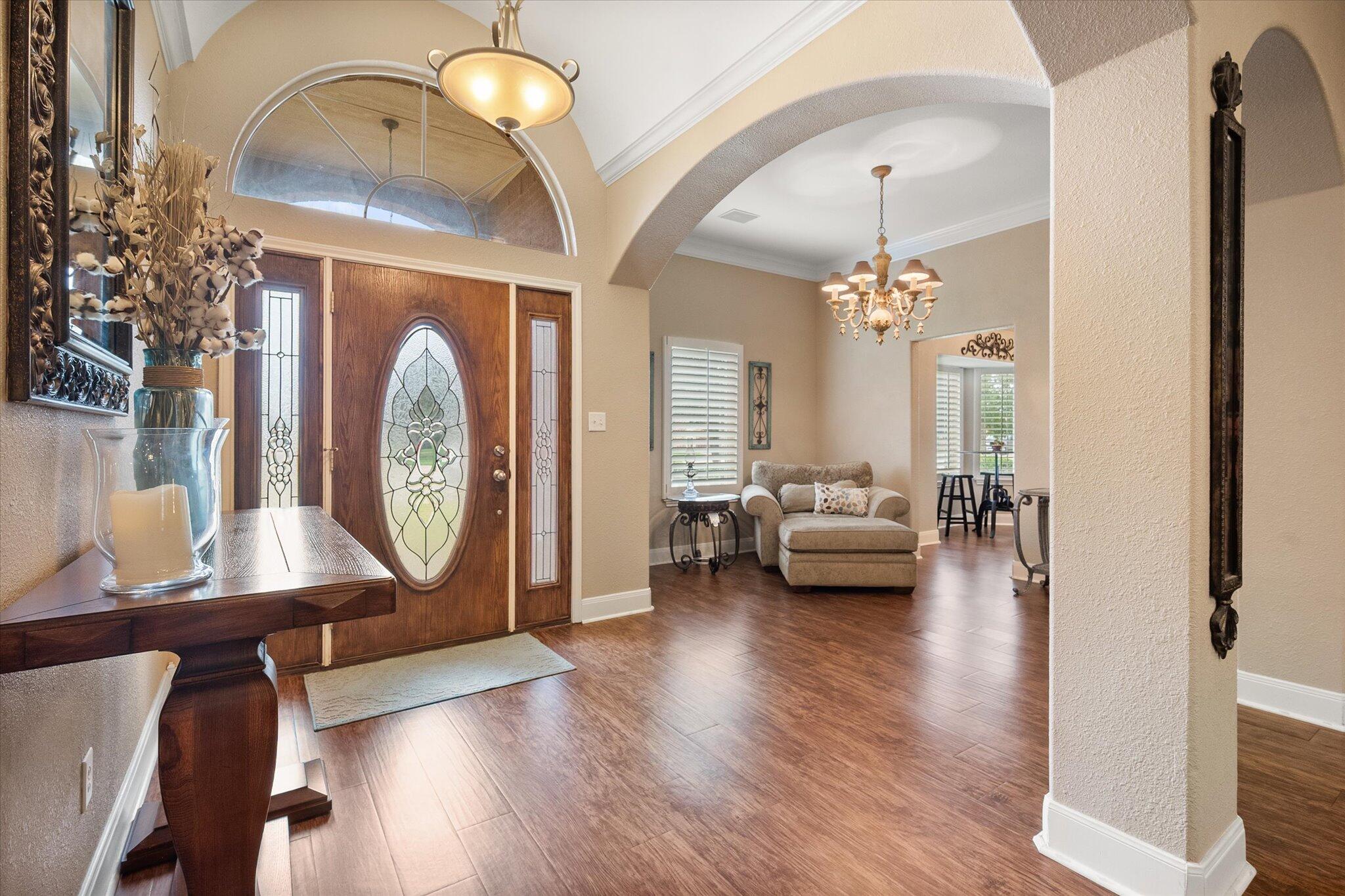 5908 110th Street Lubbock, TX 79424 - Photo 4 of 31 a living room with furniture and a chandelier