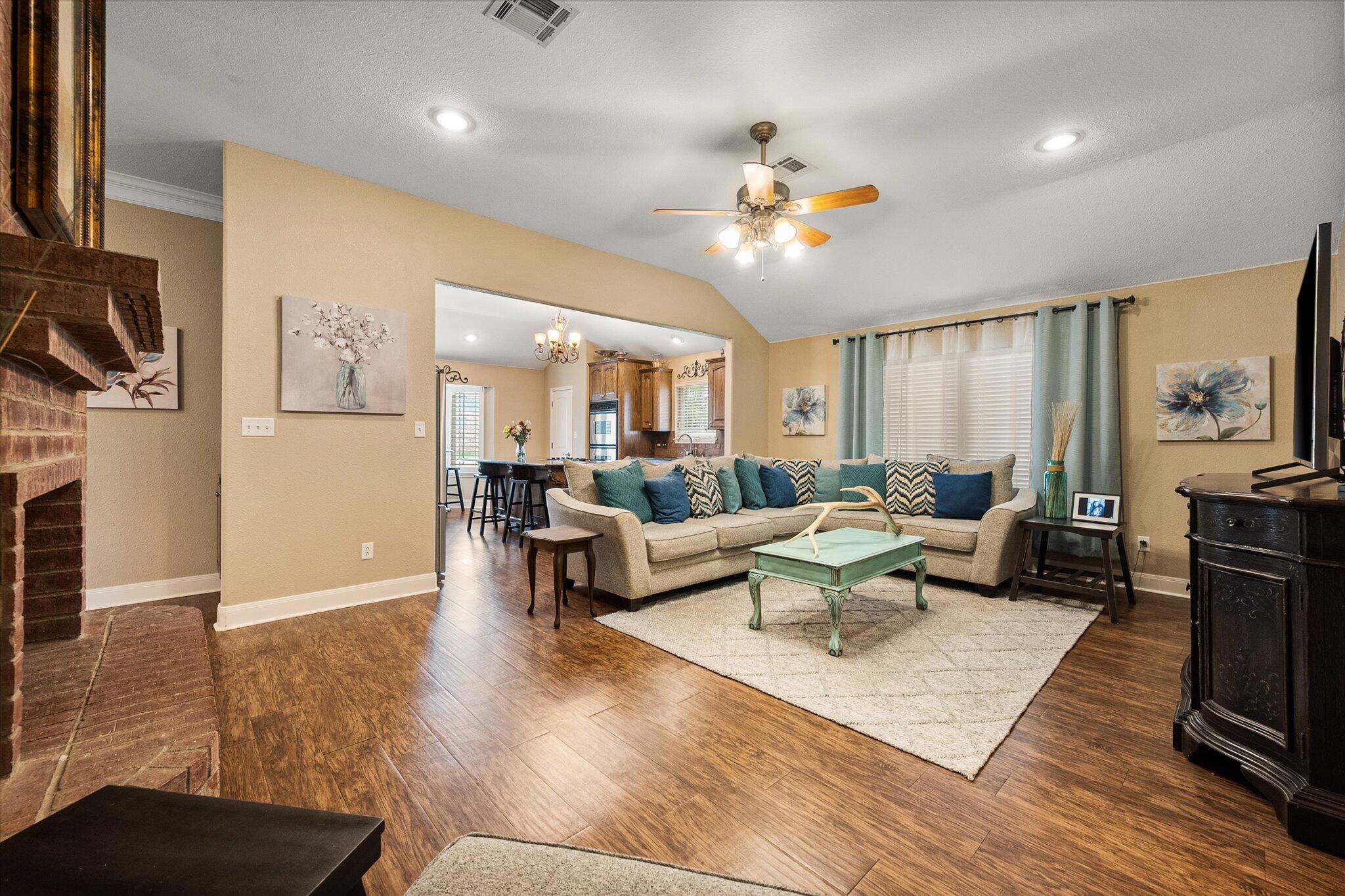 5908 110th Street Lubbock, TX 79424 - Photo 10 of 31 a living room with furniture a flat screen tv and a fireplace