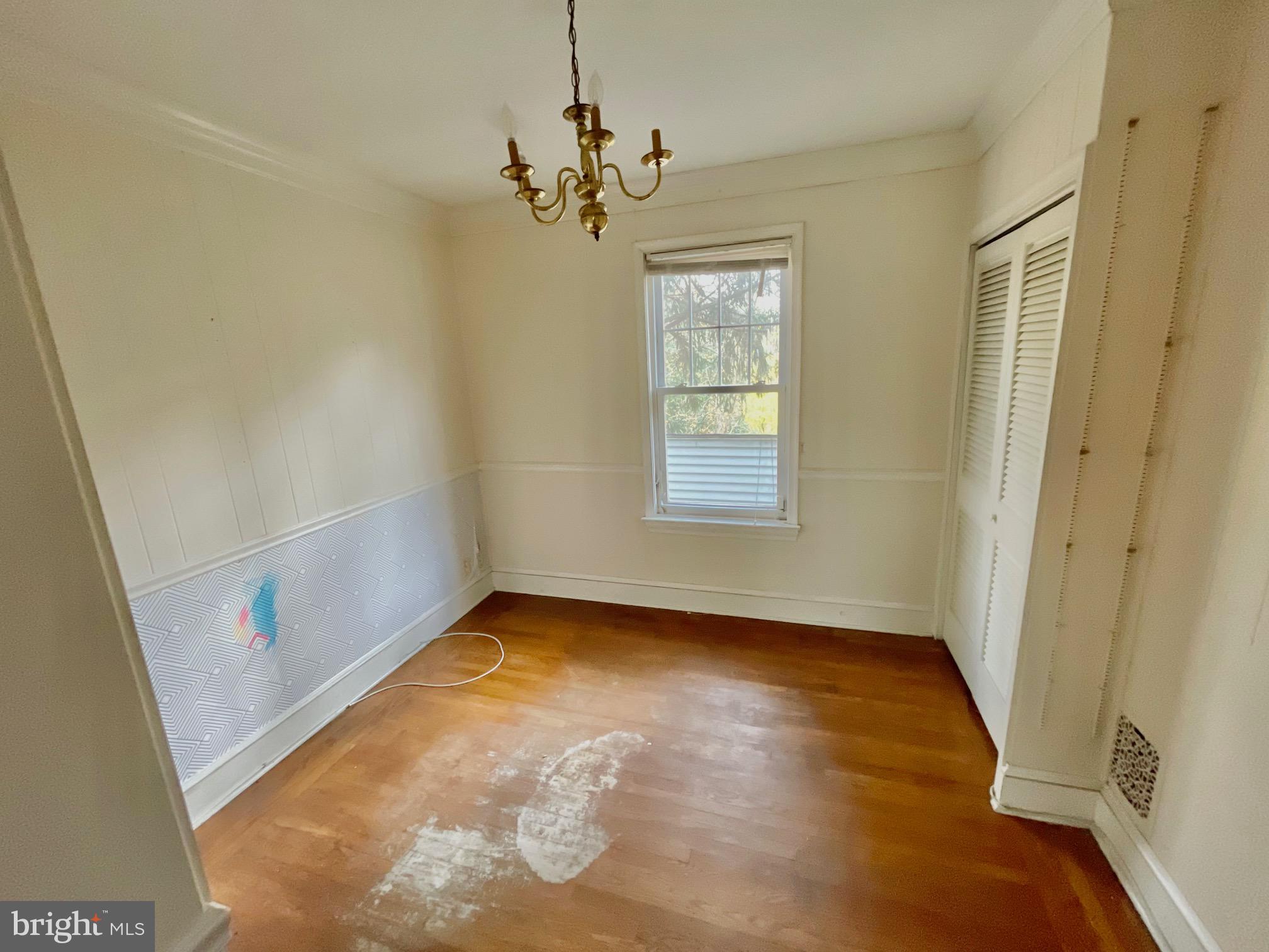 7723 Mill Road Elkins Park, PA 19027 - Photo 11 of 17 a view of an empty room with wooden floor and a window