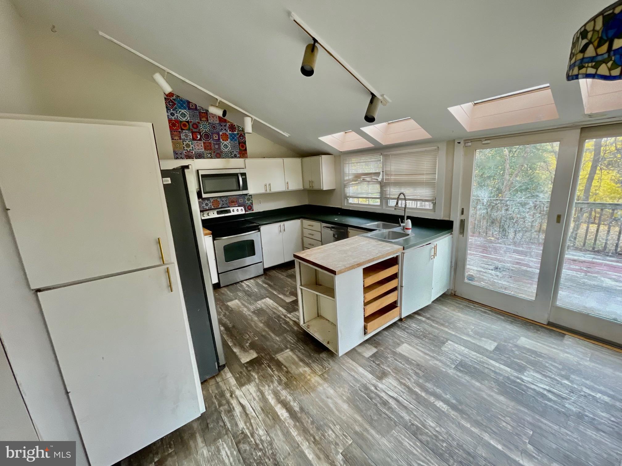 7723 Mill Road Elkins Park, PA 19027 - Photo 9 of 17 a kitchen with stainless steel appliances a stove a refrigerator and cabinets