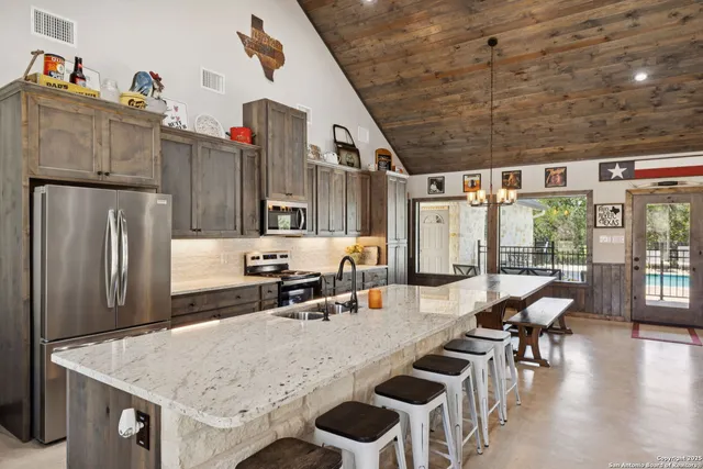 a view of kitchen with sink and refrigerator