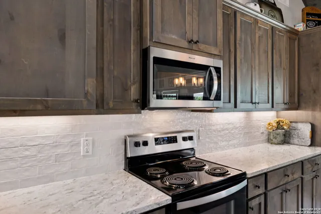 a kitchen with a stove a sink and a microwave