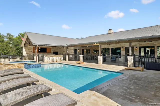 a view of a house with swimming pool and sitting area