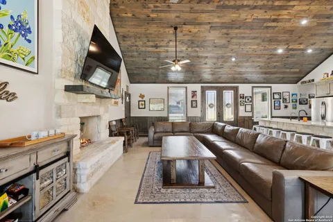 a living room with furniture a flat screen tv and a fireplace