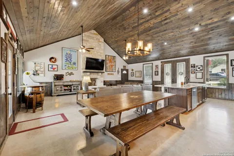 a living room with furniture a rug and kitchen view