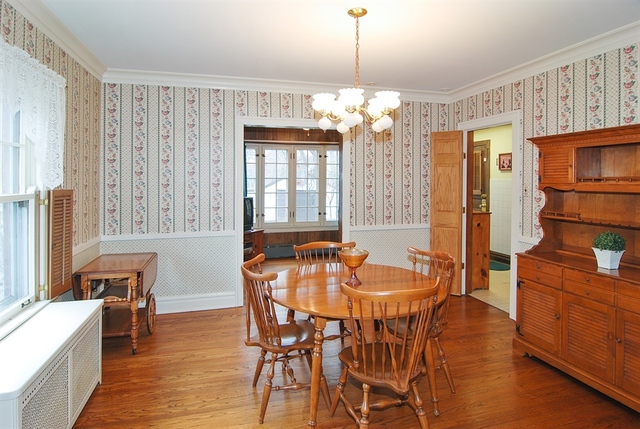131 Lawton Road Riverside, IL 60546 - Photo 5 of 16 a dining room with furniture a chandelier and wooden floor