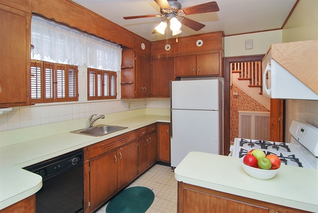 131 Lawton Road Riverside, IL 60546 - Photo 6 of 16 a kitchen with stainless steel appliances a sink stove and refrigerator