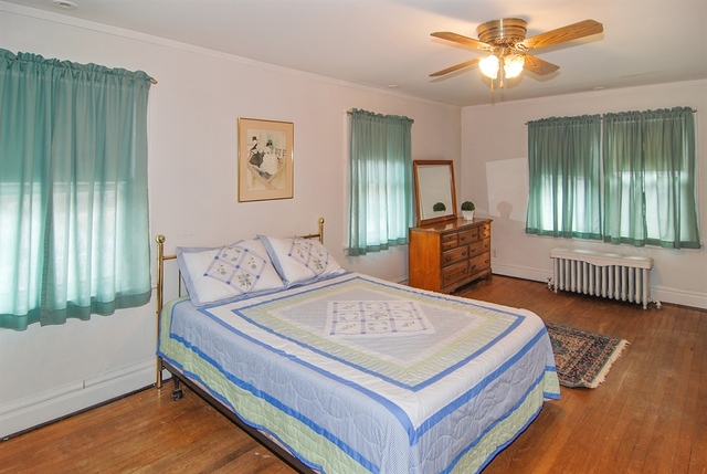 131 Lawton Road Riverside, IL 60546 - Photo 9 of 16 a bedroom with a bed and a chandelier