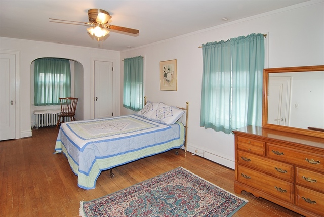 131 Lawton Road Riverside, IL 60546 - Photo 10 of 16 a bedroom with a bed and a chandelier