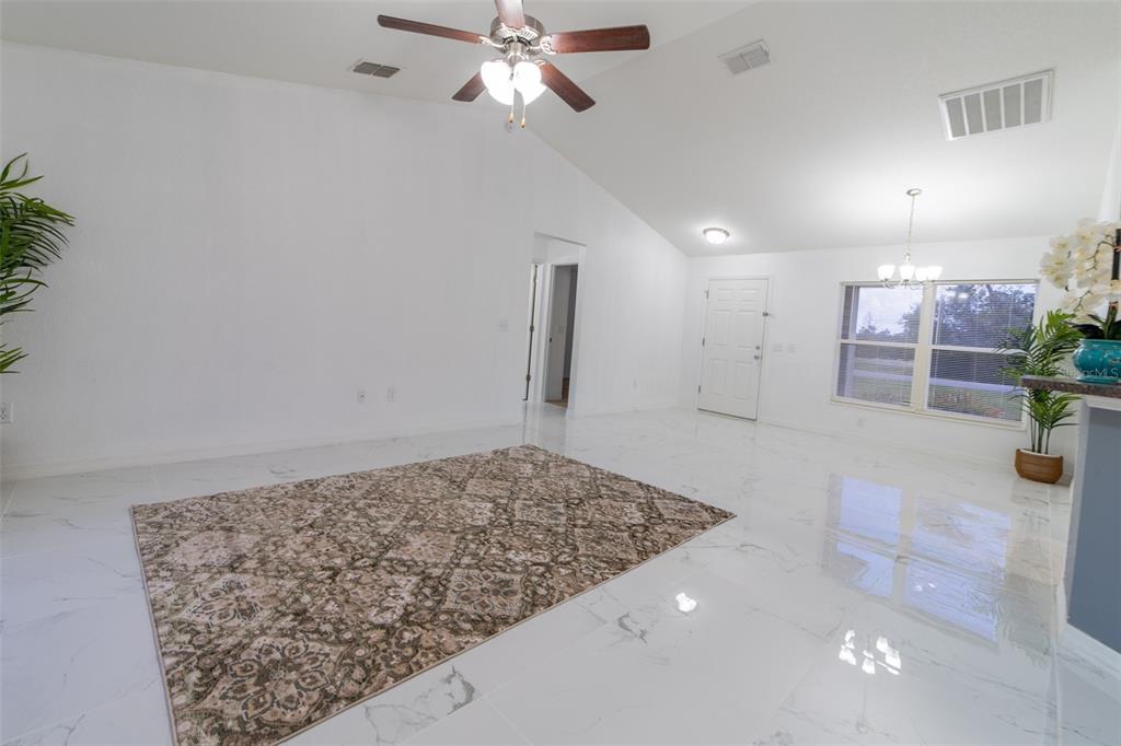5107 Southwest 165th St Road Ocala, FL 34473 - Photo 7 of 34 a view of a livingroom and a chandelier