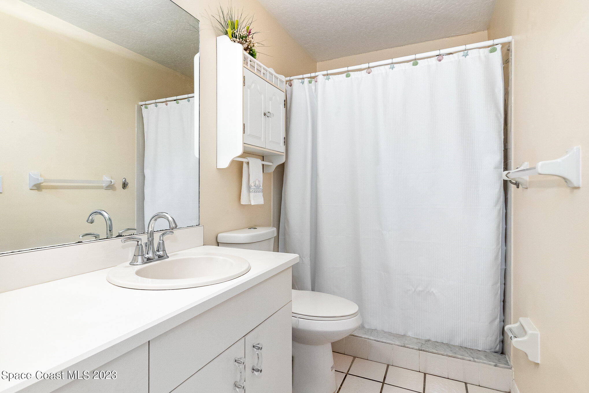 2399 Angel Road Palm Bay, FL 32909 - Photo 13 of 26 a bathroom with a sink a toilet and shower
