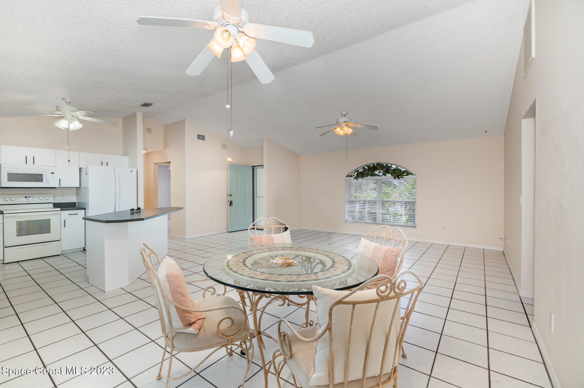 2399 Angel Road Palm Bay, FL 32909 - Photo 7 of 26 a kitchen with stainless steel appliances kitchen island granite countertop a sink and a refrigerator