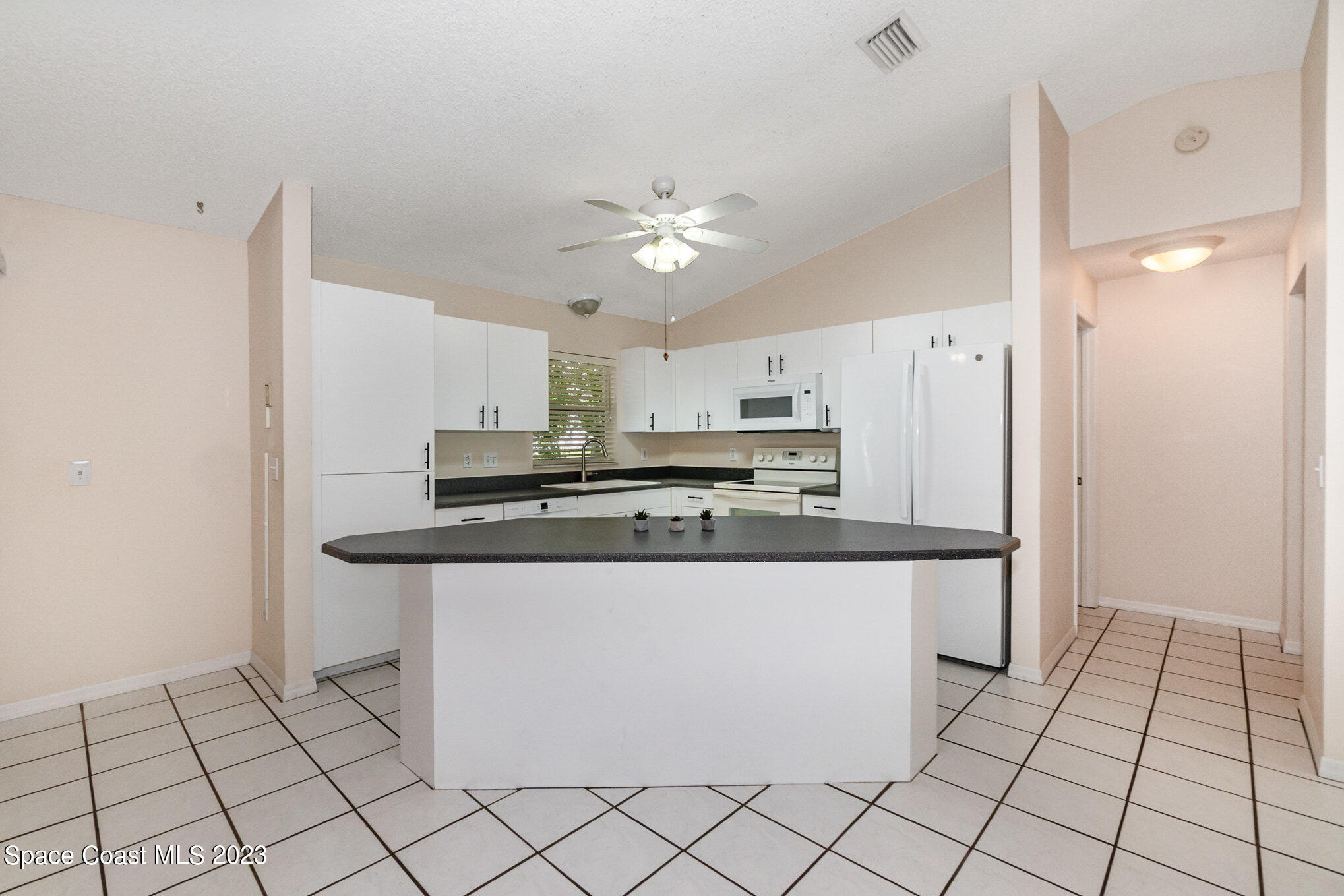2399 Angel Road Palm Bay, FL 32909 - Photo 8 of 26 a kitchen with stainless steel appliances a sink and a refrigerator