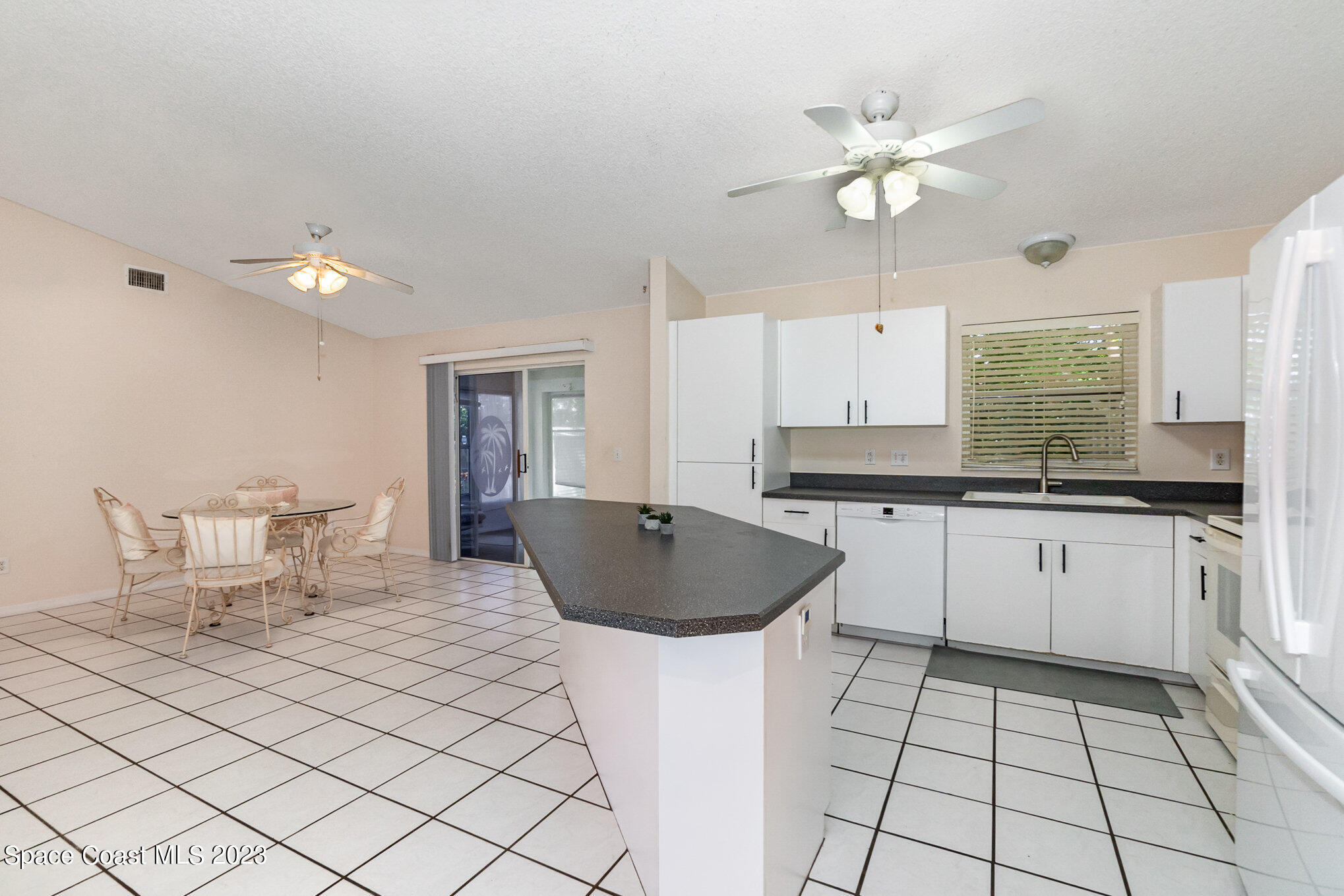 2399 Angel Road Palm Bay, FL 32909 - Photo 10 of 26 a kitchen with a sink cabinets and window