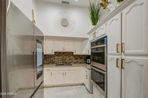 a kitchen with stainless steel appliances a stove a refrigerator and cabinets