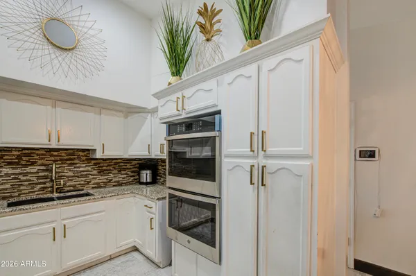 a kitchen with stainless steel appliances a white refrigerator freezer a sink and dishwasher