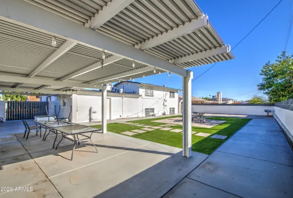 a view of a patio with a table chairs and a patio