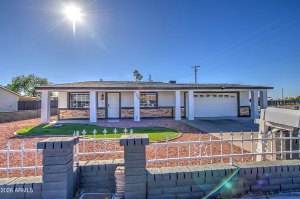 a front view of a house with swimming pool having outdoor seating