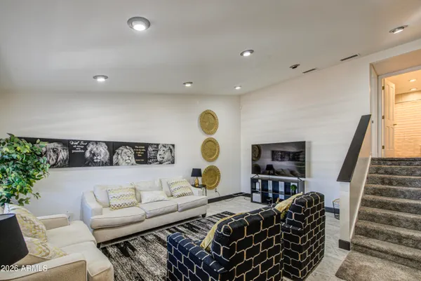 a living room with furniture and wooden floor