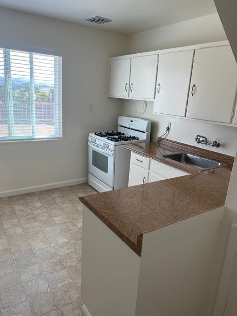 630 Manor Drive Pacifica, CA 94044 - Photo 5 of 17 a kitchen with granite countertop a stove and a sink
