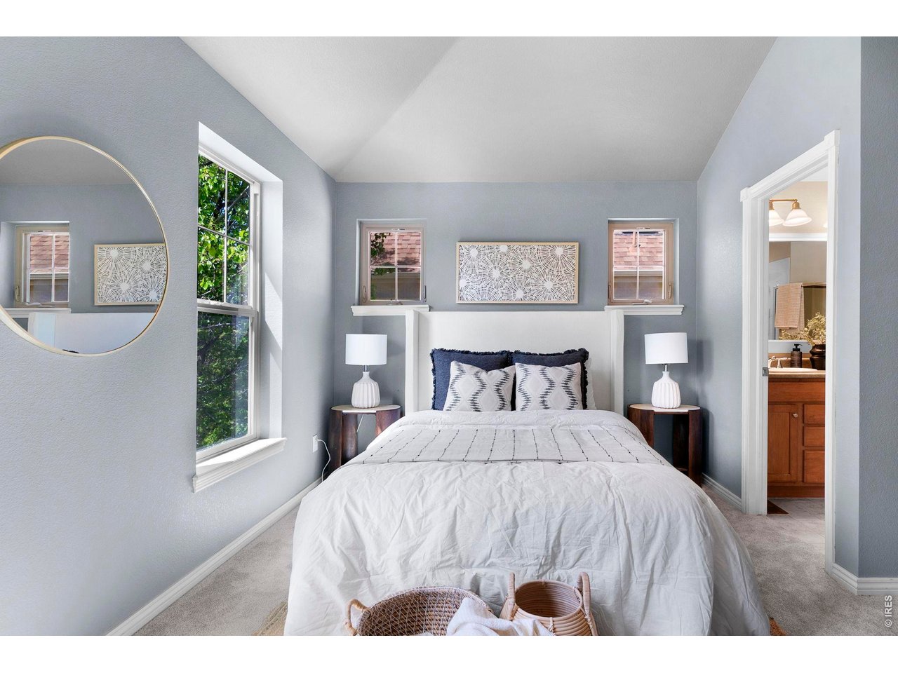 654 Homestead Street Lafayette, CO 80026 - Photo 13 of 31 a bedroom with a bed and a large mirror