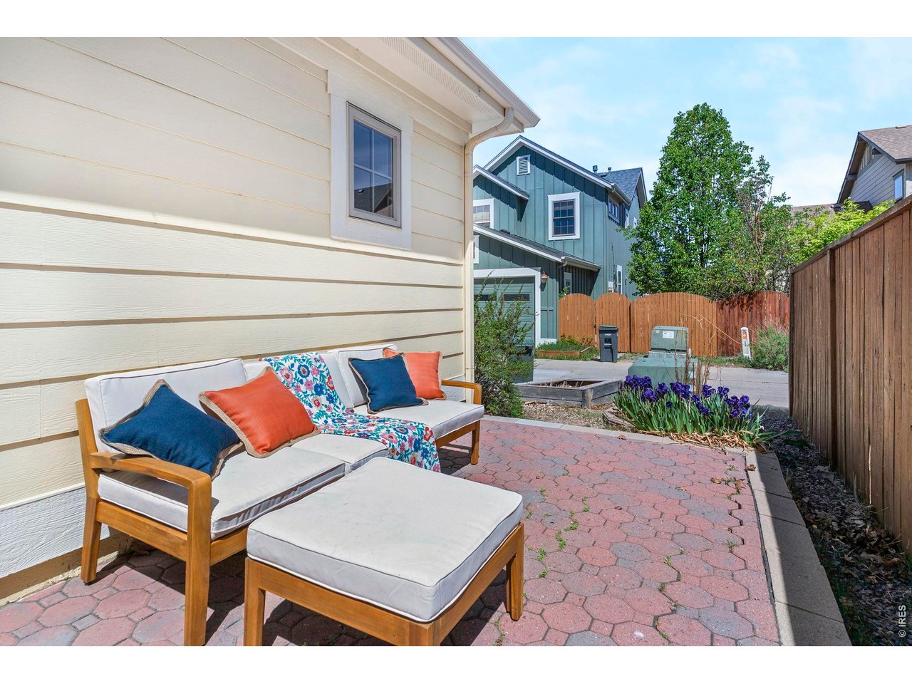 654 Homestead Street Lafayette, CO 80026 - Photo 26 of 31 a view of a patio with couches and table and chairs next to a yard