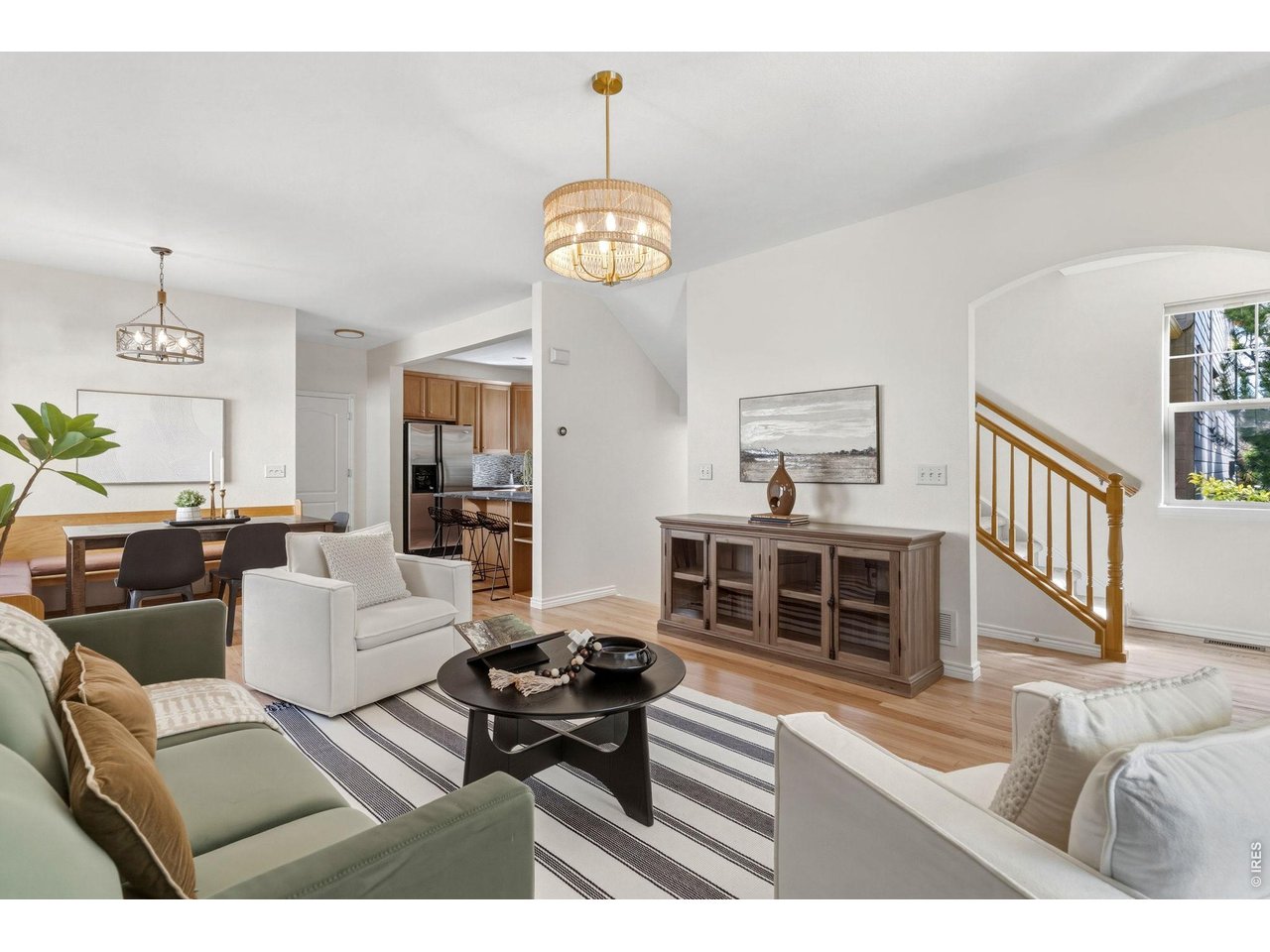 654 Homestead Street Lafayette, CO 80026 - Photo 5 of 31 a living room with furniture a rug and a chandelier