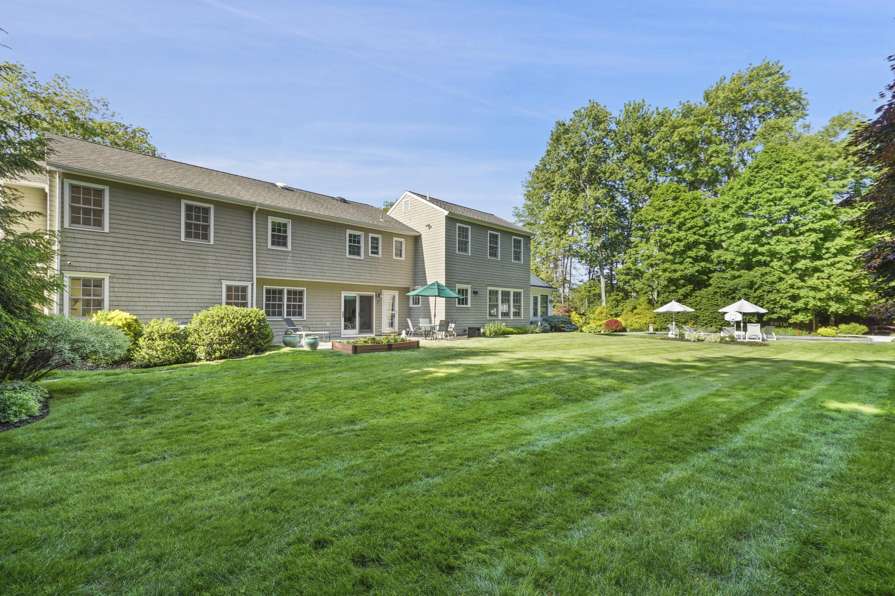 34 Summit Ridge Road New Canaan, CT 06840 - Photo 19 of 28 a view of a house with a big yard plants and large trees
