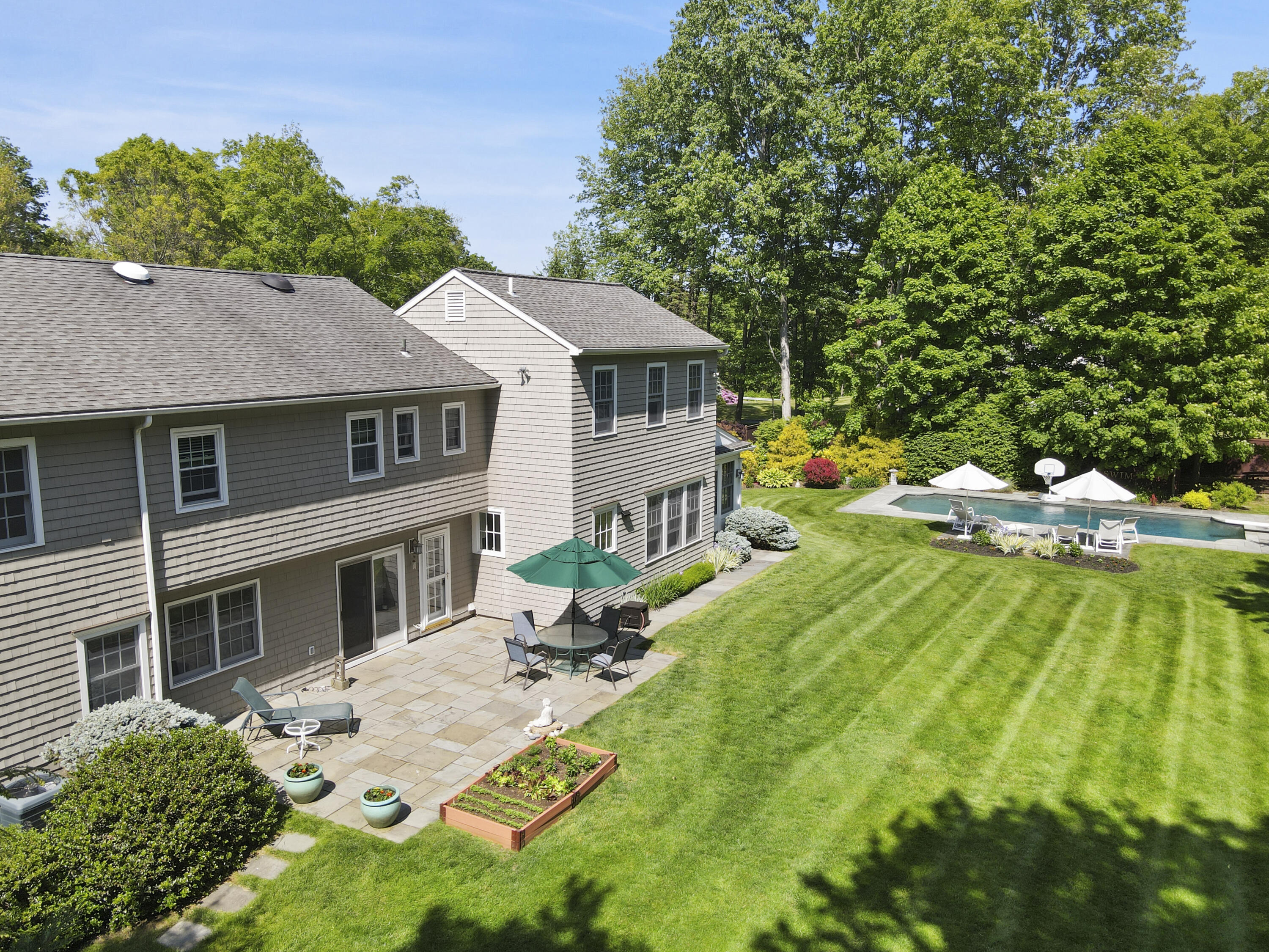 34 Summit Ridge Road New Canaan, CT 06840 - Photo 21 of 28 a view of a house with pool and garden