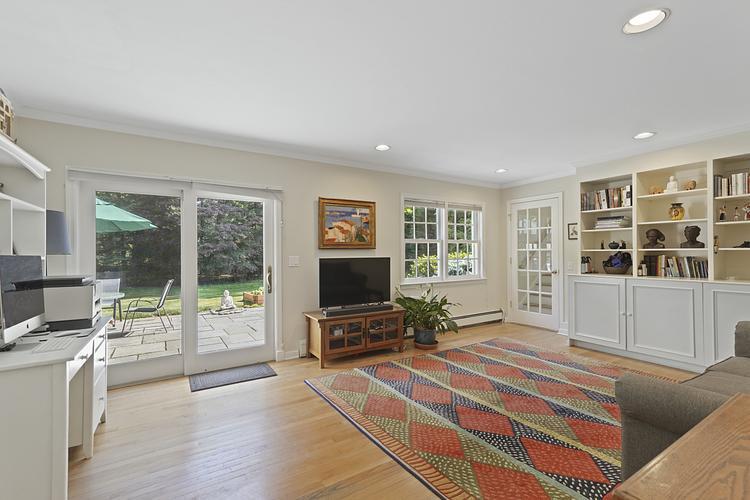 34 Summit Ridge Road New Canaan, CT 06840 - Photo 8 of 28 a living room with furniture a flat screen tv and floor to ceiling window