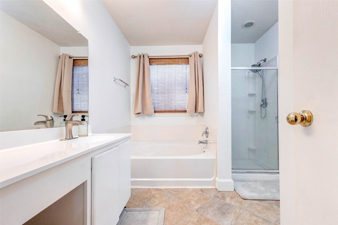 822 Autumn Point Lane Spring, TX 77373 - Photo 19 of 26 Primary bathroom with vanity area and spa tub and walk in shower