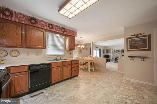 a large kitchen with stainless steel appliances granite countertop a sink and dishwasher a stove top oven with wooden floor