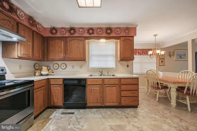 a kitchen with cabinets and chairs