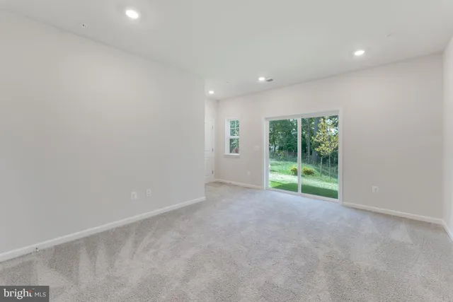 a view of an empty room with glass door
