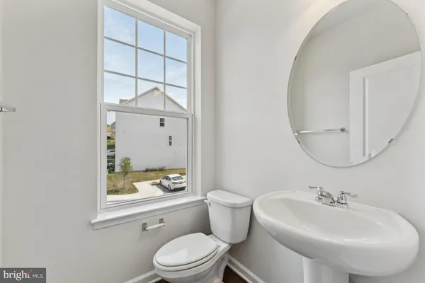 a bathroom with a toilet a sink and a mirror